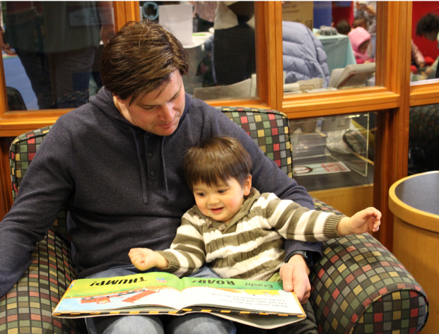Father reading to young son