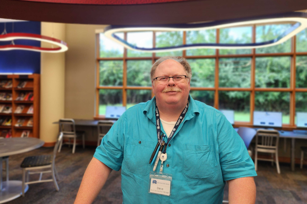 Librarian Steve Ketcham smiling in the Main Library's teen room