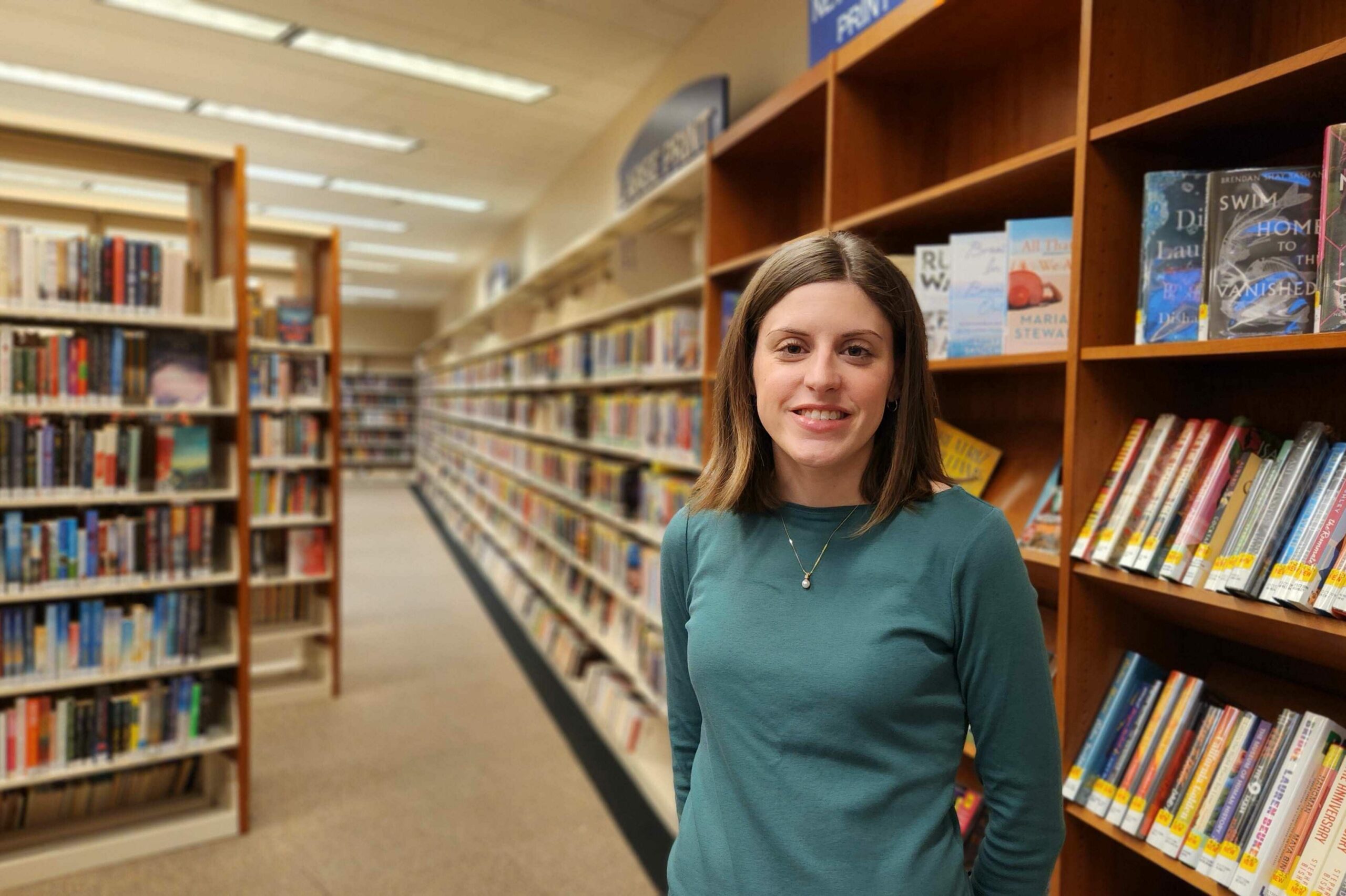 Megan Fillinger near new books at the Main Library