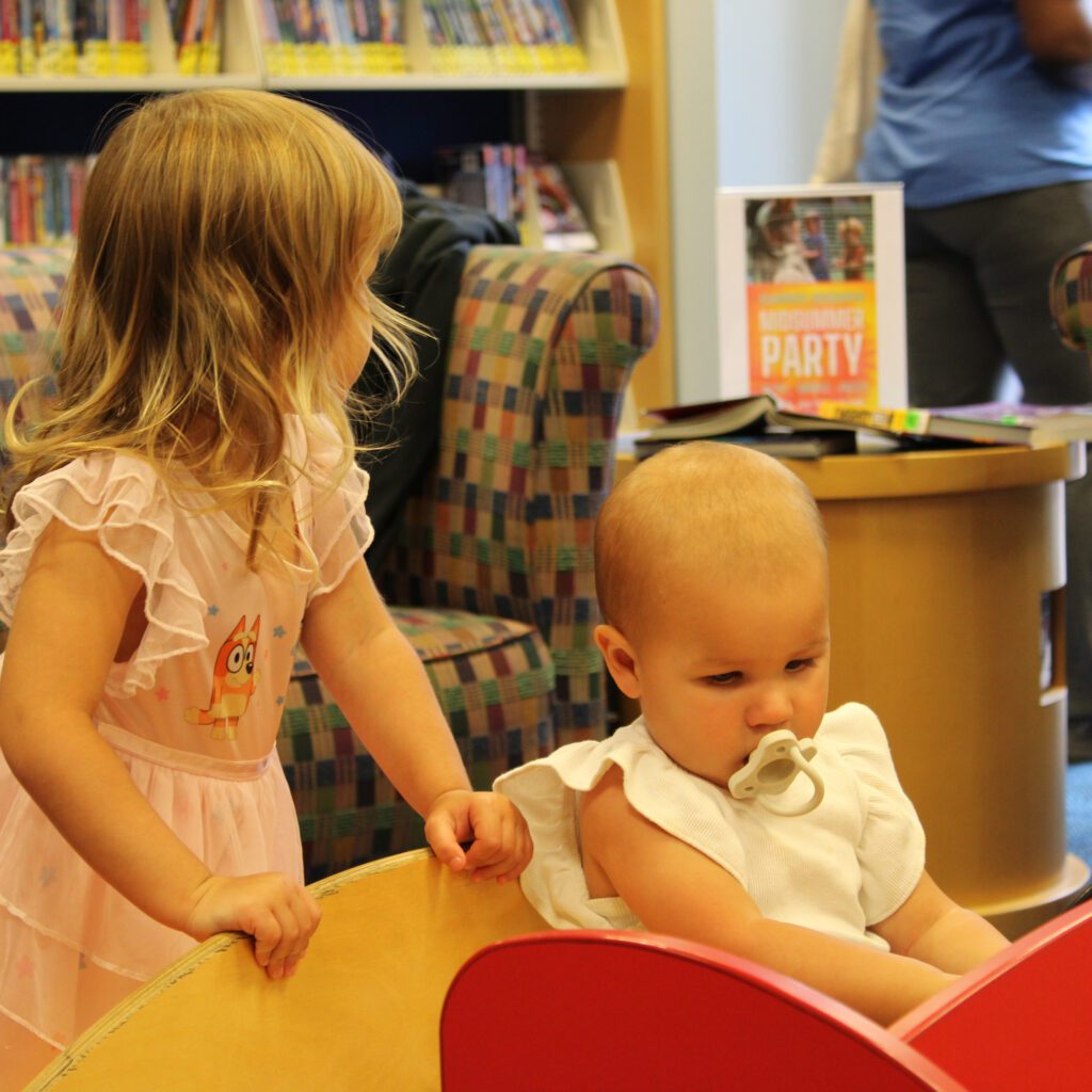 baby playing with toy car at the Westacres Branch