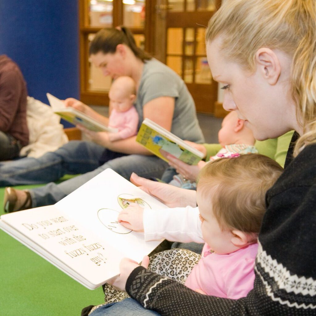 parent reading to child in the Youth Activity Center