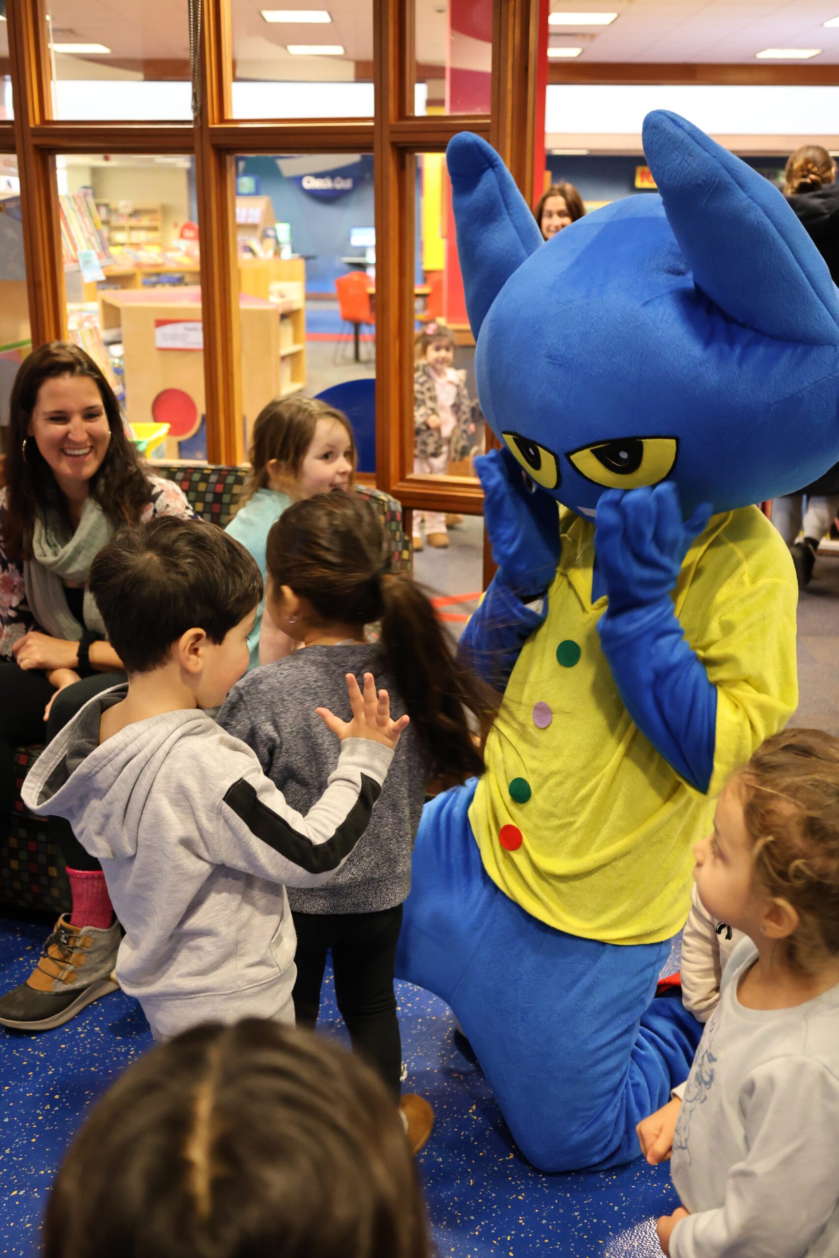 Pete the Cat costumed character meeting kids at the library