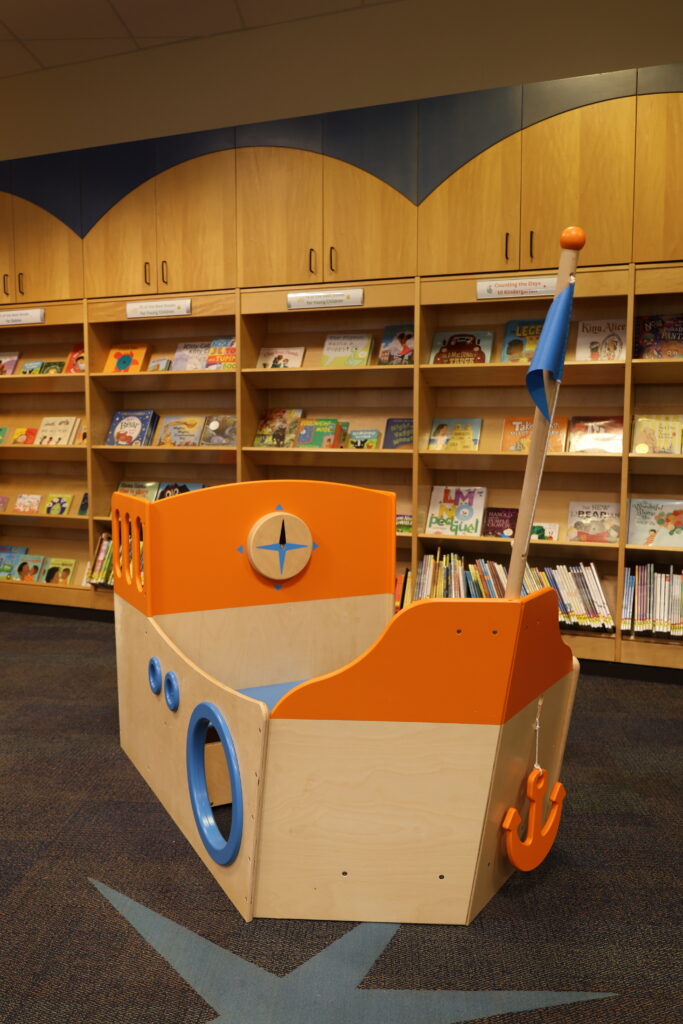Wooden boat play structure in the Youth Room at the Main Library
